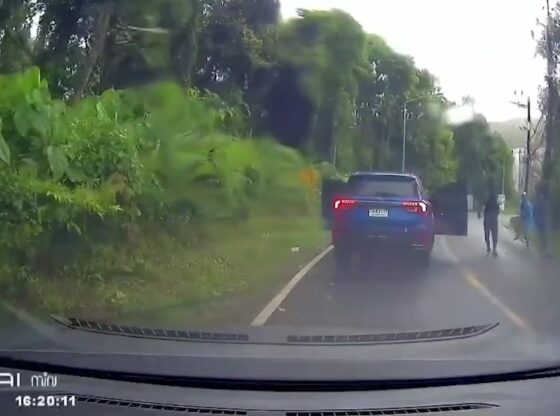 Dashcam footage of an SUV stopped on a road, with doors open and people emerging from the vehicle.