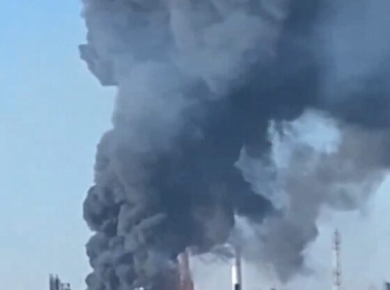 Large plumes of black smoke and fire rise from an industrial plant.