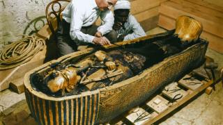 Howard Carter examining Tutankhamun's third coffin, the solid gold one. Photo: Griffith Institute