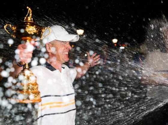 Captain Luke Donald of Team Europe holds the Ryder Cup trophy as he is doused with champagne after winning the 2025 Ryder Cup at Black Course at Bethpage State Park Golf Course in Farmingdale, New York on September 28, 2025.