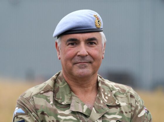 Major General Paul Tedman in military fatigues and blue beret.