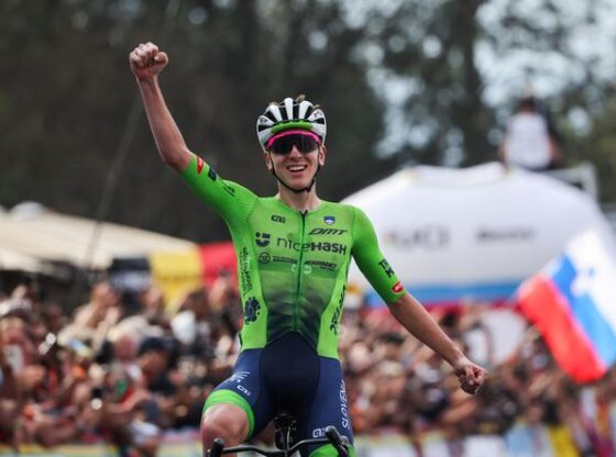 Slovenian rider Tadej Pogacar celebrates as he crosses the finish line to win the men's Elite road race cycling event during the 2025 World Championships, in Kigali, Rwanda, on September 28, 2025.