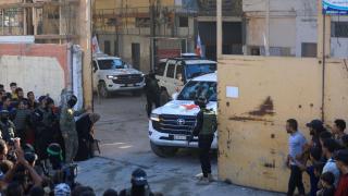Hamas militiamen monitoring the release of Israeli hostages.
