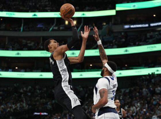 Victor Wembanyama of the San Antonio Spurs shoots over Anthony Davis of the Dallas Mavericks, on October 22, 2025 in Dallas, Texas.