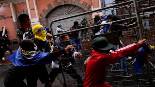 Protesters tear down a barricade during a protest against Noboa in Quito on September 23.